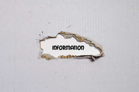 The word information appearing behind torn paperの写真素材
