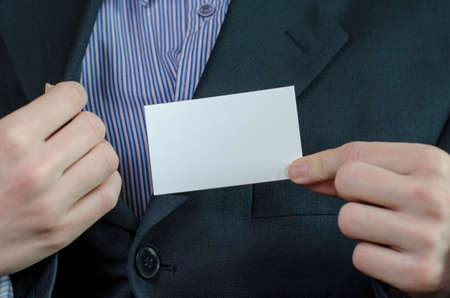 Business woman hand holding white empty noteの写真素材