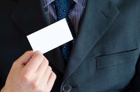Business man hand holding white empty note