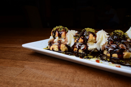 Delicious profiteroles dessert on tableの写真素材