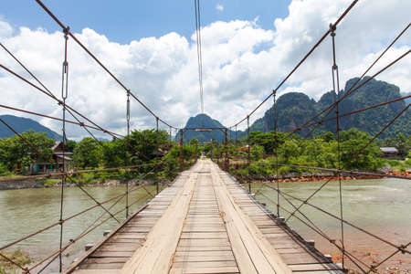 Wooden bridge over Nam Song river, Vang Vieng village, Laosの写真素材