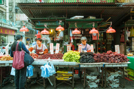 Woman buying vegetables in the street market, Hong Kong, February 17, 2014.のeditorial素材