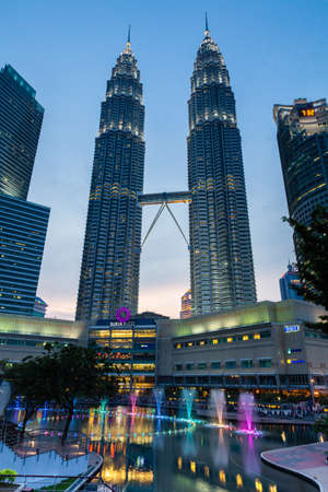Kuala Lumpur, Malaysia -  24 July 2014: Fountain show at night in front of Petronas Twin Towers and Suria KLCC mall on July 24, 2014, Kuala Lumpur, Malaysia.のeditorial素材