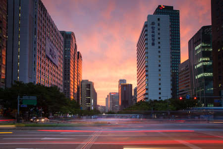 Seoul, Republic of Korea - 14 August 2014: The view of vibrant sunset over business area of Seoul with blurred traffic lights on the foreground, August 14, 2014, Seoul, Korea.のeditorial素材