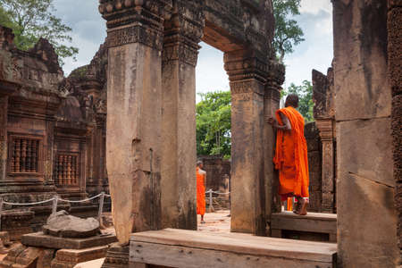 Siem Reap, Cambodia - 07 May 2014: Buddhist monks observing Banteay Srei Temple, one of the temples of legendary Angkor Complex on 07 May 2014, Seam Reap, Cambodia.のeditorial素材