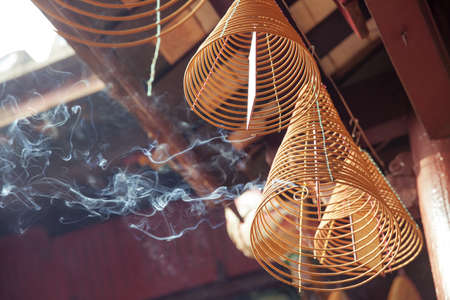 Burning incense in Quan Cong Temple, Hoi An, Vietnam