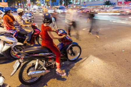 Ho Chi Minh City, Vietnam - November 19, 2015: Motorbike driver are waiting for the green signal at the crossroad on November 19, 2015 in Ho Chi Minh City, Vietnam.のeditorial素材