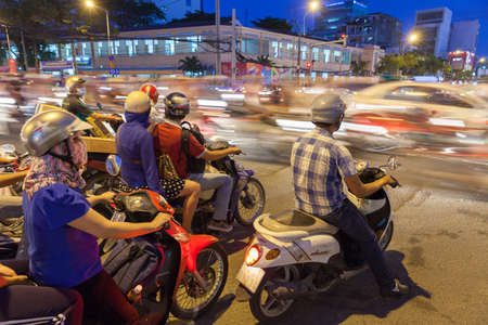 Ho Chi Minh City, Vietnam - November 19, 2015: Motorbike driver are waiting for the green signal at the crossroad on November 19, 2015 in Ho Chi Minh City, Vietnam.のeditorial素材