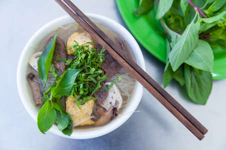 Vegan version of Pho famous vietnamse noodle soup, served with fresh herbs at the buddhist eatery,...