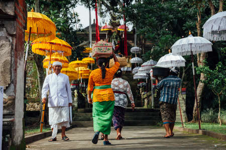 Ubud, Indonesia - March 02, 2016: Balinese people in traditional clothes  going to the temple with offerings during Balinese New Year or Nyepi Day celebrations on March 02, 2016 in Ubud, Bali.のeditorial素材