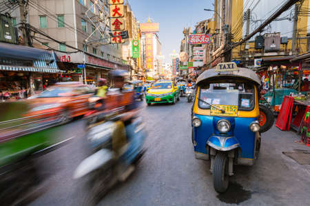 Bangkok, Thailand - April 24, 2016: Tuk-tuk taxi parked near street market in Chinatown on April 24, 2016 in Bangkok, Thailand.のeditorial素材
