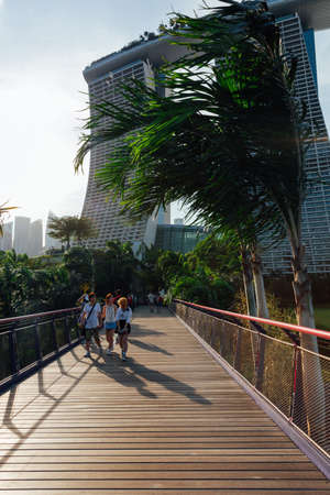 SINGAPORE, SINGAPORE - FEBRUARY 17: Touristis walking at the Gardens By The Bay park with Marina Bay Sands Building on the background on February 17, 2016 in Singapore.のeditorial素材