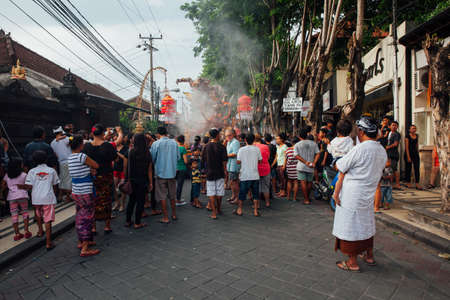 Kuta, Indonesia - March 08, 2016:  Visitors watch the Ogoh-ogoh statues at the parade on the eve of Nyepi day on March 08, 2016 in Kuta, Bali, Indonesiaのeditorial素材
