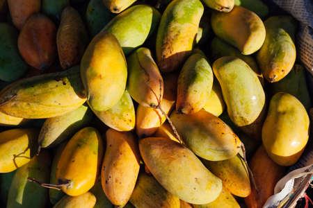 Basket with mangoes at the street market, Vietnamの写真素材
