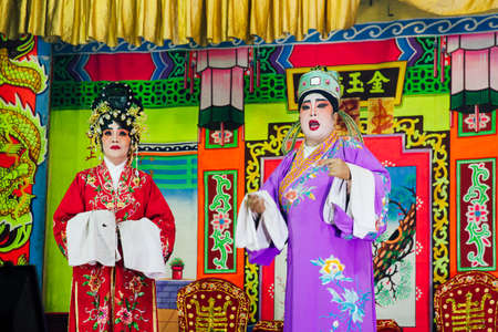 George Town, Malaysia - March 26, 2016: Actors playing traditional Chinese Opera on the street scene, George Town, Penang, Malaysia on March 26, 2016.のeditorial素材