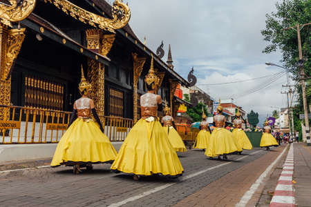 Chiang Mai, Thailand - August 24, 2016: Young girls in festival costumes parade near the ancient temple on August 24, 2016 in Chiang Mai, Thailand.のeditorial素材