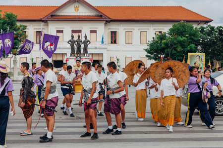 Chiang Mai, Thailand - August 24, 2016: Young boys and girls in festival costumes parade near the Three Kings Monument on August 24, 2016 in Chiang Mai, Thailand.のeditorial素材