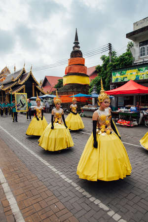 Chiang Mai, Thailand - August 24, 2016: Young girls in festival costumes parade near the ancient temple on August 24, 2016 in Chiang Mai, Thailand.のeditorial素材