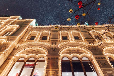 Christmas decorations in front of illuminated facade of the Central Department Store GUM on the Red...
