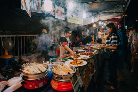 Chiang Mai, Thailand - August 27, 2016:  Thai woman sales at the Saturday Night Market on August 27, 2016 in Chiang Mai, Thailand.のeditorial素材