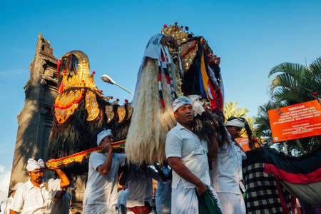 Bali, Indonesia - March 07, 2016: Balinese people in traditional clothes carry jempana or wooden litter at the procession during Balinese New Year celebrations.のeditorial素材