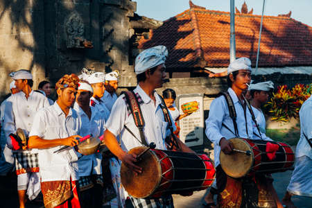 Bali, Indonesia - March 07, 2016: Balinese traditional musicians play the gamelan at the ceremonial procession during Balinese New Year celebrations.のeditorial素材