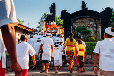 Bali, Indonesia - March 07, 2016: Balinese people in traditional clothes carry jempana or wooden litter at the procession during Balinese New Year celebrations.のeditorial素材