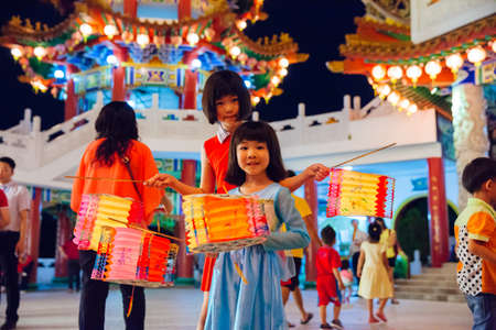 Kuala Lumpur, Malaysia - September 15, 2016:  Little girls pose with paper lanterns at Thean Hou Temple at the lantern parade during Mid-Autumn festival on September 15, 2016 in Kuala Lumpur, Malaysia.のeditorial素材