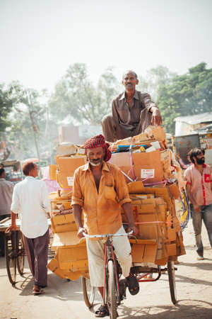 Delhi, India - September 18, 2014: Cycle rickshaw riding the vehicle under the heat on the street of Old Delhi, India on September 18, 2014.のeditorial素材