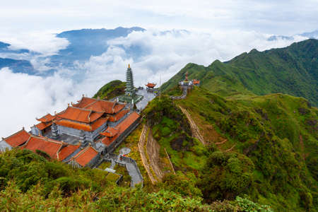 Stunning view of mountains and the temple from the summit of the Fansipan Mountain, Sapa, Lao Cai, Vietnamのeditorial素材