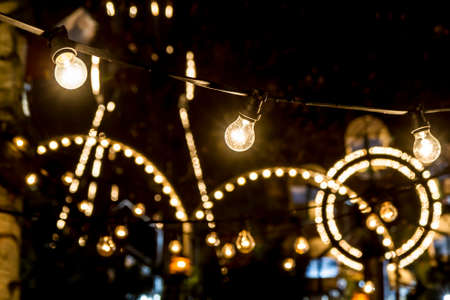Close-up of three Lights hanging in amusement parkの写真素材