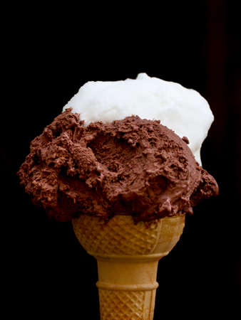 two  lemon and chocolate  scoops of Ice Cream in a waffle coneの写真素材