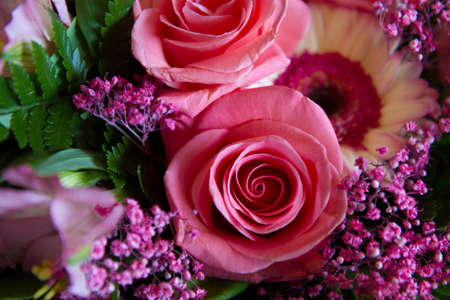 Achievements and anniversaries are often congratulated with bouguet of flowers including red roses.の写真素材