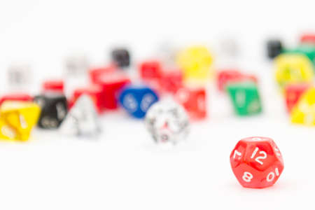 Image of 12-sided RPG dice with other dice on background. RPGs and boardgames use dices with different amount of sides like d4, d6, d8, d10, d12 and d20.の写真素材