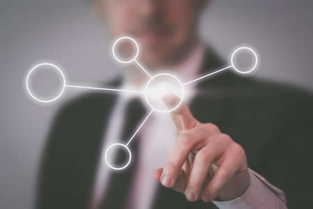 Businessman touching modular network connections symbol in virtual UIの写真素材
