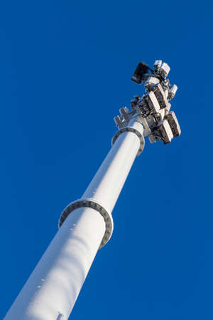 Mobile cell tower and transmitters and receivers against blue clear sky