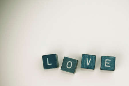 word Love written with wooden tiles on an isolated background.の写真素材
