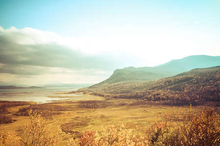 Norwegian landscape with mountain and fjord in fall colorsの写真素材