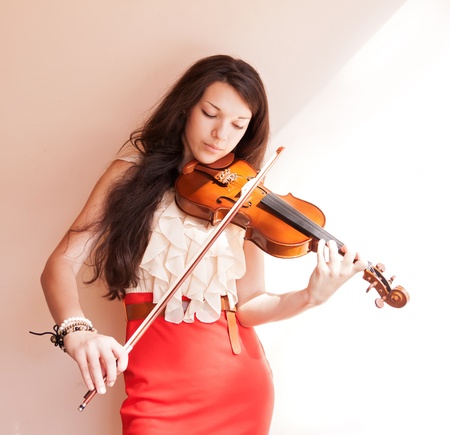 Pretty young female playing the violin, soft focus  