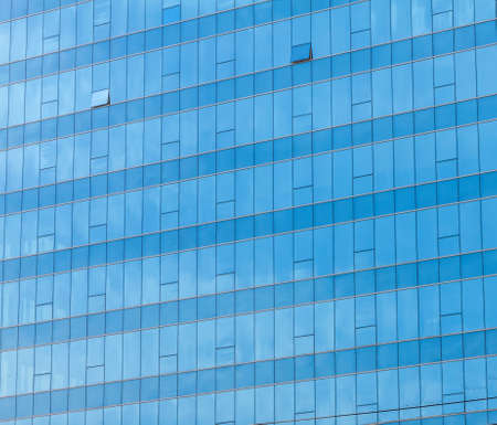 Blue sky reflected in the glass building. 