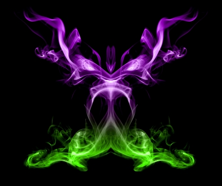 Green and purple smoke on a black background like a butterfly の写真素材