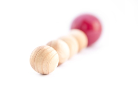 Row of balls with one different red ball. の写真素材