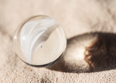 One glass ball on cloth background の写真素材
