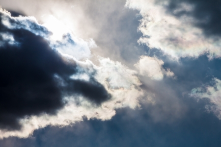 Sky with dark clouds and sun. With lens flare. の写真素材