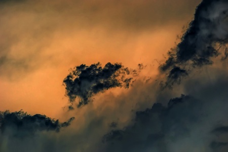     Dramatic sunset with clouds reflected in water  の写真素材