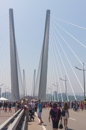 VLADIVOSTOK, RUSSIA - JULY 7: Flashmob "I love Vladivostok" on the "Golden Bridge". It was attended by 26,904 people who   have created a "live" 707-meter Russian flag for 5 minutes for Guinness world record on July 7, 2013 in Vladivostok, Russia. のeditorial素材