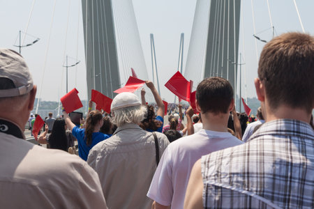 VLADIVOSTOK, RUSSIA - JULY 7: Flashmob "I love Vladivostok" on the "Golden Bridge". It was attended by 26,904 people who   have created a "live" 707-meter Russian flag for 5 minutes for Guinness world record on July 7, 2013 in Vladivostok, Russia. のeditorial素材