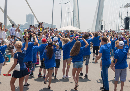 VLADIVOSTOK, RUSSIA - JULY 7: dance Flash mob on the "Golden Bridge". It was attended by hundred people who danced on   the "Golden Bridge" on July 7, 2013 in Vladivostok, Russia. のeditorial素材
