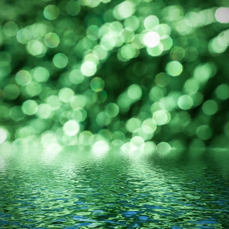   Abstract circular green bokeh reflected in water  の写真素材