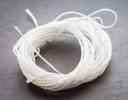  Coil of white rope on a dark background の写真素材
